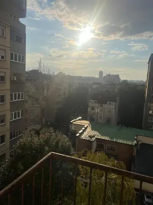 a view of a city with the sun in the sky at Oasis Residences B in Belgrade