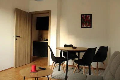 a living room with a table and chairs at Oasis Residences B in Belgrade