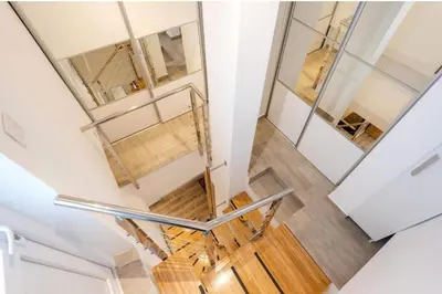 a staircase in a house with a glass case at Dorcol deluxe apartment in Belgrade