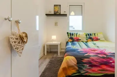 a bedroom with a bed with a colorful blanket at Dorcol deluxe apartment in Belgrade