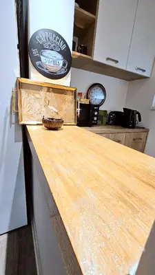 a counter in a kitchen with a wooden counter top at Dorcol deluxe apartment in Belgrade
