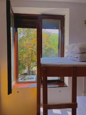 a bunk bed in a room with a window at Happy Cat Old Town Hostel in Belgrade