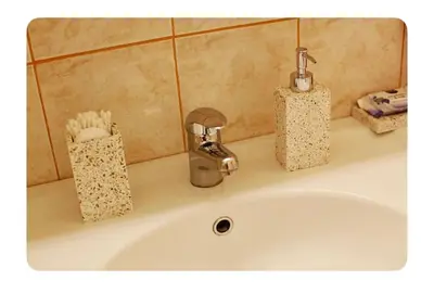 a bathroom sink with a faucet and tooth brushes at Luxury Apartment 8 in Belgrade