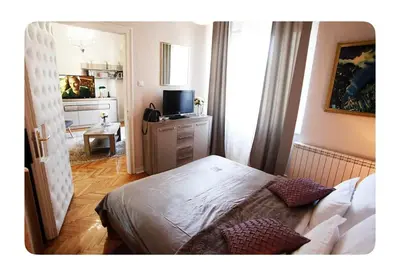 a bedroom with a bed and a television in it at Luxury Apartment 8 in Belgrade
