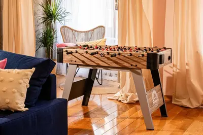 a chess board on a table in a living room at Play Cloud with Cinema & Foosball Old Town Heart in Belgrade
