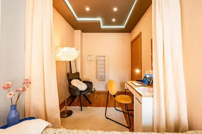 a bedroom with a desk and a chair in a room at Play Cloud with Cinema & Foosball Old Town Heart in Belgrade