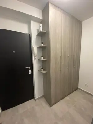 a room with a door and a closet with shelves at Vist 2 apartment in Tošin Bunar