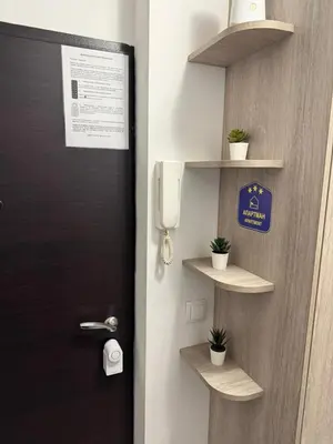 a door with a pay phone and some plants at Vist 2 apartment in Tošin Bunar