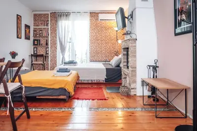a bedroom with a bed and a fireplace at King Residences City Center in Belgrade