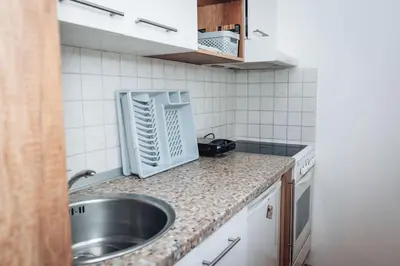 a kitchen with a sink and a counter top at King Residences City Center in Belgrade
