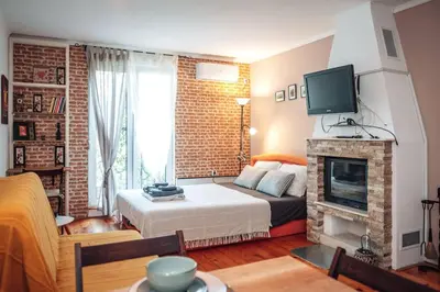 a living room with a bed and a fireplace at King Residences City Center in Belgrade