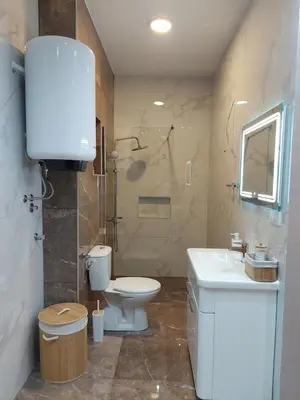 a bathroom with a toilet and a sink and a shower at Stan na dan PREMIUM 1 Obrenovac in Obrenovac