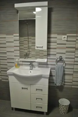 a bathroom with a white sink and a mirror at Apartments DANI in Skorenovac