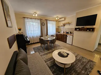 a living room with a couch and a table at Prenoćište Lana 2 in Novi Banovci
