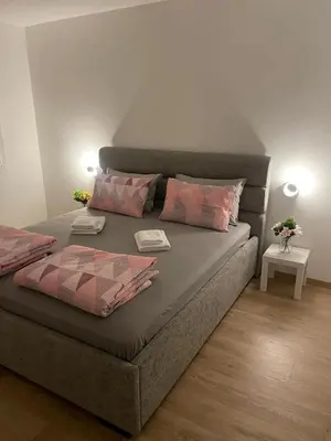 a bed with two pillows at Sollemio in Novi Beograd