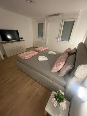 a large bed in a living room with a couch at Sollemio in Novi Beograd