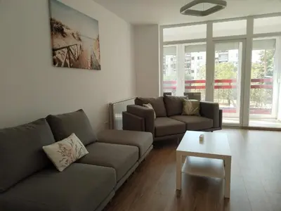 a living room with two couches and a coffee table at Sollemio in Novi Beograd