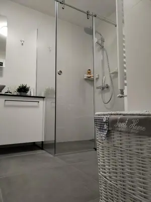 a bathroom with a shower with a glass door at Sollemio in Novi Beograd