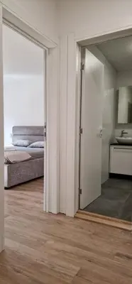 a bedroom with a mirror and a bed in a room at Sollemio in Novi Beograd