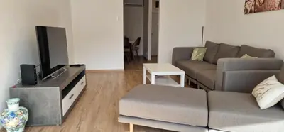 a living room with a couch and a tv at Sollemio in Novi Beograd
