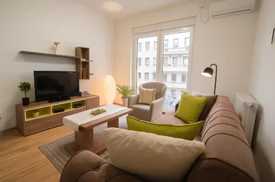 a living room with a couch and a tv at 3 BDR for 6 CENTER CLOSE TO NATIONAL MUSEUM in Belgrade