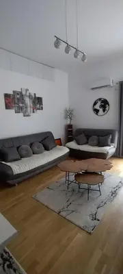 a living room with a couch and a table at apartman Elena in Zemun