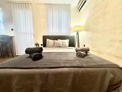 a bedroom with a large bed with a lamp on it at Amazing apartman in Bele Vode in Bele Vode