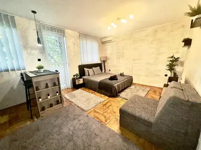 a living room with a couch and a table at Amazing apartman in Bele Vode in Bele Vode