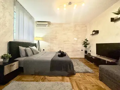 a bedroom with a bed and a flat screen tv at Amazing apartman in Bele Vode in Bele Vode