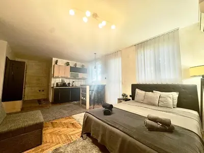 a bedroom with a bed and a couch in a room at Amazing apartman in Bele Vode in Bele Vode