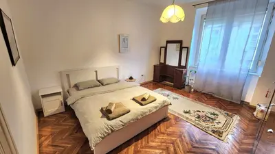 a bedroom with a bed with two pillows on it at 85m large, bright and cozy Bona Apartment in Belgrade