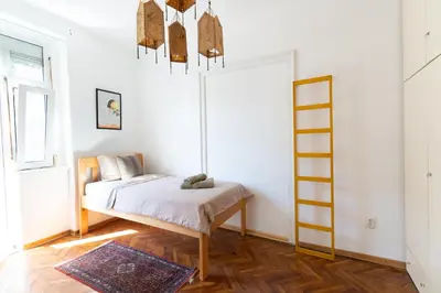 a room with a bed and a ladder in it at 85m large, bright and cozy Bona Apartment in Belgrade
