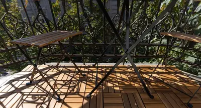 a chair and a table on a patio at 85m large, bright and cozy Bona Apartment in Belgrade