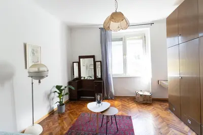 a living room with a table and a window at 85m large, bright and cozy Bona Apartment in Belgrade