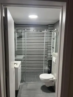 a bathroom with a toilet and a sink and a shower at Apartman Katarina in Pančevo