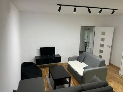 a living room with two couches and a tv at Apartman Katarina in Pančevo