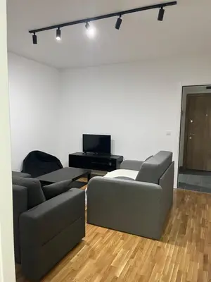 a living room with a couch and a tv at Apartman Katarina in Pančevo