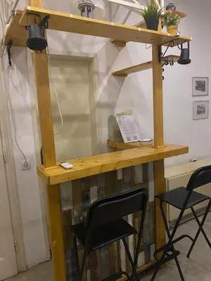 a wooden desk with two chairs in a room at LEO Apartment in Belgrade