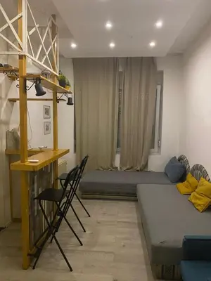 a room with a bed and a desk and chairs at LEO Apartment in Belgrade