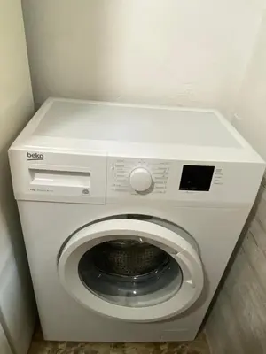 a white washer and dryer in a room at LEO Apartment in Belgrade