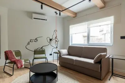 a living room with a couch and chairs at HostGost Selected Suites - Skadarlija Artisan in Belgrade