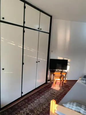 a living room with white cabinets and a television at Arena 23 in Novi Beograd