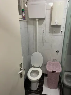 a small bathroom with a toilet and a trash can at Arena 23 in Novi Beograd