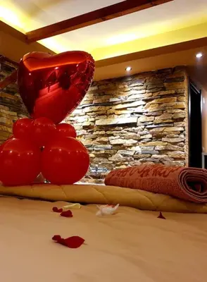 a pile of tomatoes sitting on top of a bed at Stone Spa Apartman in Sremčica