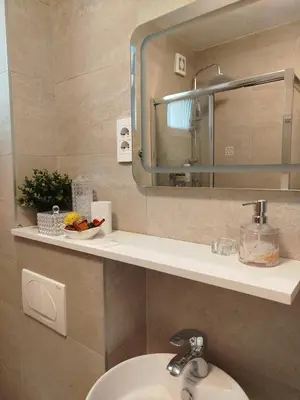 a bathroom with a sink and a mirror at Apartman Alfa in Smederevo
