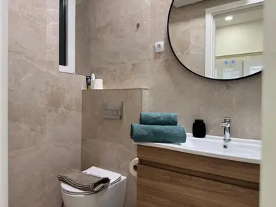 a bathroom with a toilet and a sink and a mirror at Maison Danube in Belgrade