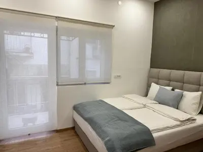 a bedroom with a large bed with a window at Maison Danube in Belgrade