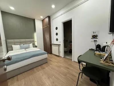 a bedroom with a bed and a desk in it at Maison Danube in Belgrade