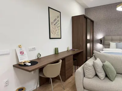 a bedroom with a desk and a bed and a chair at Maison Danube in Belgrade