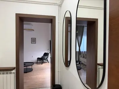 a room with a mirror and a living room at Maison Danube in Belgrade